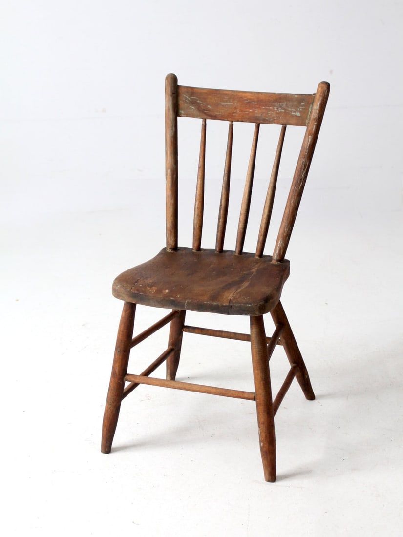 Antique Farmhouse Chair Rustic Plank Seat Tapered Spindle Back: Antique Farmhouse Chair Rustic Plank Seat Tapered Spindle Back This antique farmhouse chair showcases a beautifully timeworn finish and a sturdy, simple design. Its solid plank seat, tapered spindle b