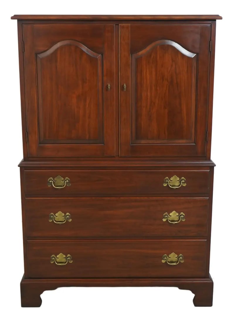 Cherry Wood High Chest with Raised Panel Doors and Bracket Feet: Cherry Wood High Chest with Raised Panel Doors and Bracket Feet This Henkel Harris chifferobe high chest, crafted in cherry wood with a brown finish, features traditional styling with bracket feet and