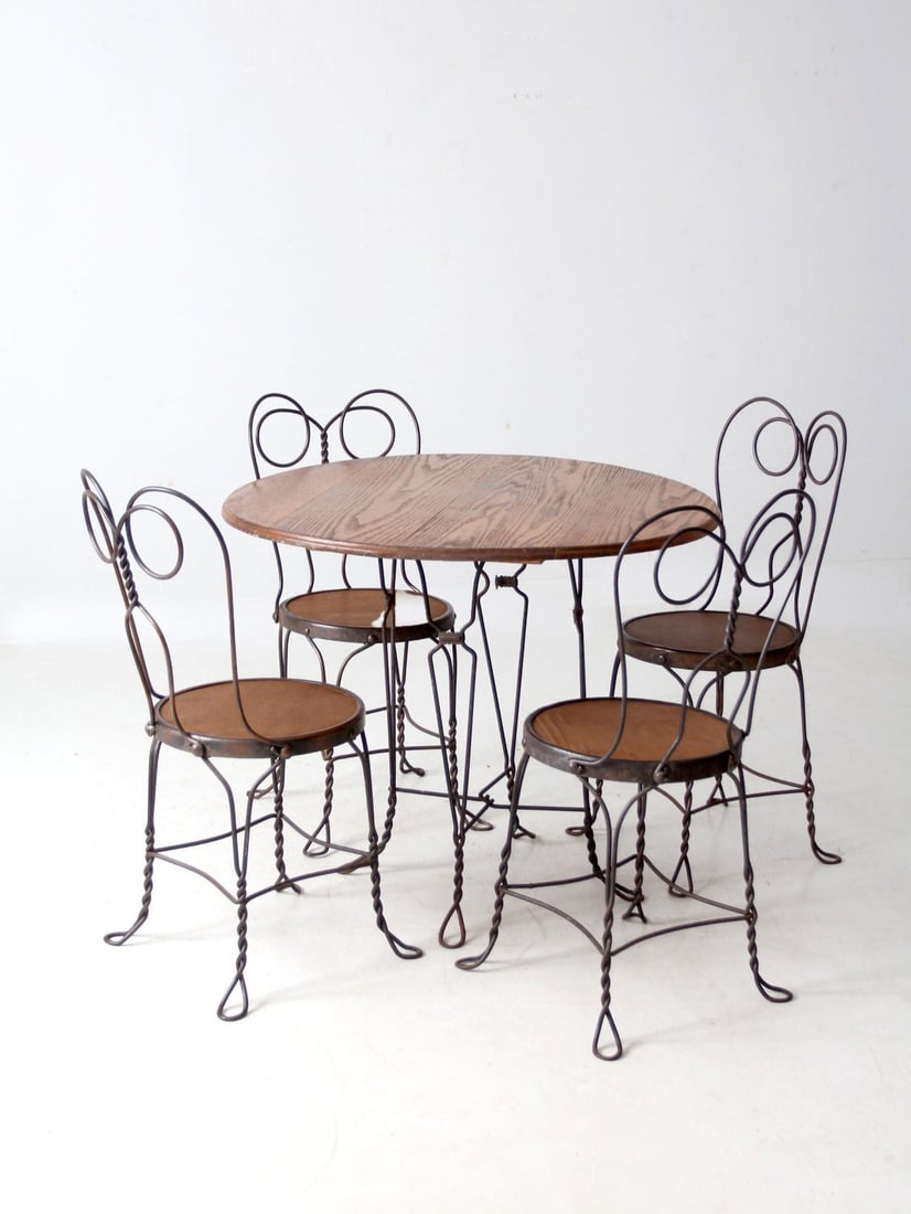 Vintage Twisted Iron Bistro Table Set with 4 Chairs: Vintage Twisted Iron Bistro Table Set with 4 Chairs This early 20th-century antique bistro table set features a beautifully twisted iron base paired with four matching chairs. Each chair showcases gra