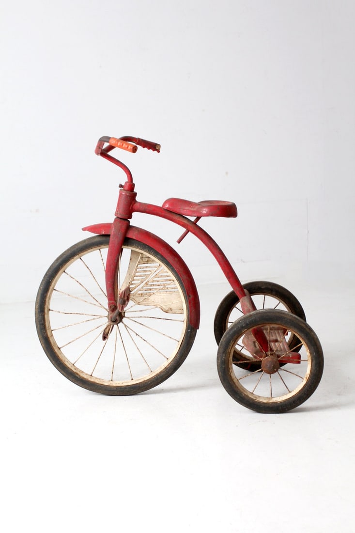 Vintage Red and White Decorative Tricycle 1930s-1950s: Vintage Red and White Decorative Tricycle 1930s-1950s This vintage decorative tricycle, dating back to the 1930s-1950s, showcases a classic red and white color scheme. It features a wire-spoked front 