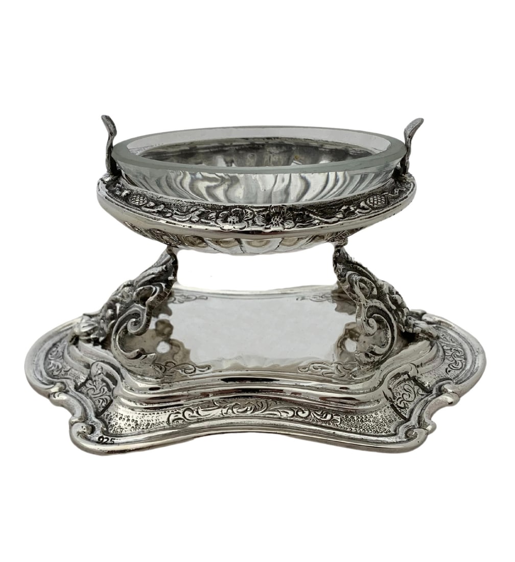 Handmade Sterling Silver and Crystal Oval Salt Holder with Stand: Handmade Sterling Silver and Crystal Oval Salt Holder with Stand This elegant salt holder features a fine 925 sterling silver body with a crystal insert. The piece showcases handmade chased ornate ova