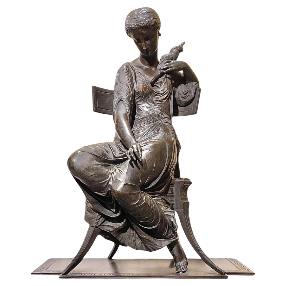 Greek Revival Patinated Bronze Statue of Seated Maiden with Spindle 19th Century: Greek Revival Patinated Bronze Statue of Seated Maiden with Spindle 19th Century This antique patinated bronze sculpture from the late 19th century features a finely detailed Greek maiden seated on a 