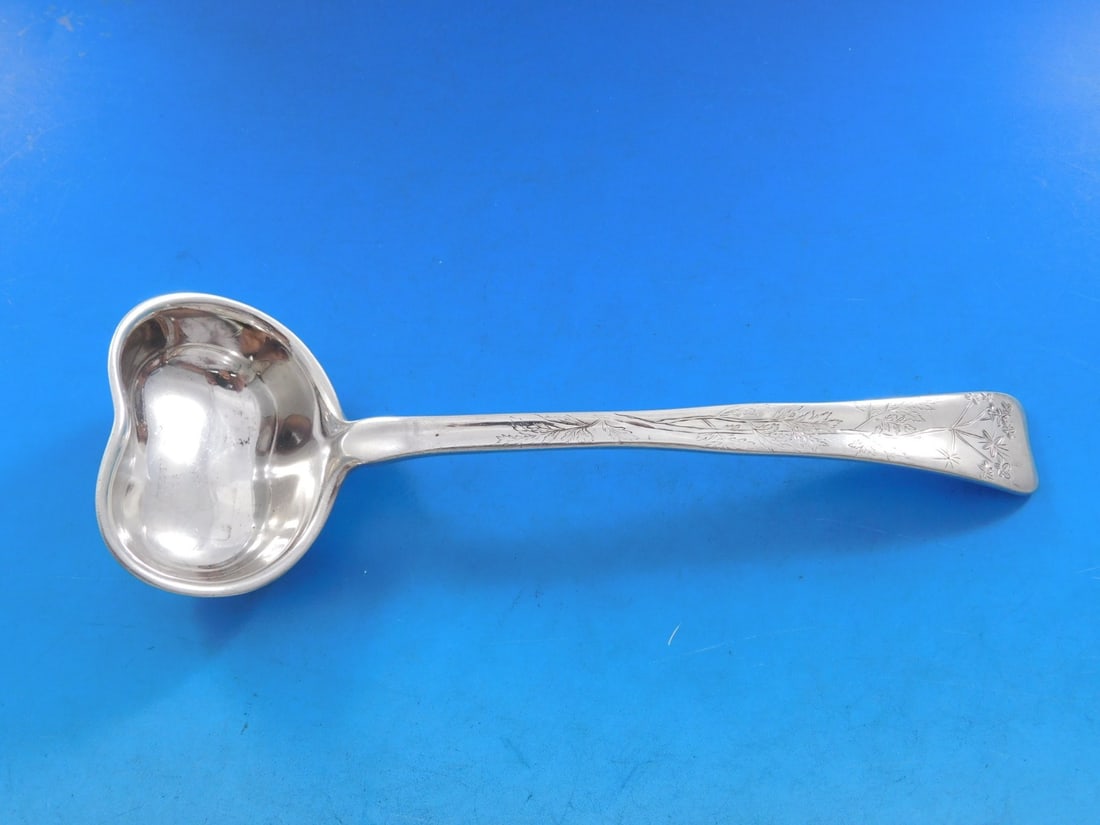 Tiffany Sterling Silver Gravy Ladle Lap Over Edge Floral 7 5/8: Tiffany Sterling Silver Gravy Ladle Lap Over Edge Floral 7 5/8 This exquisite Tiffany & Co. gravy ladle features a beautiful floral motif and is crafted from high-quality sterling silver. The ladle, m