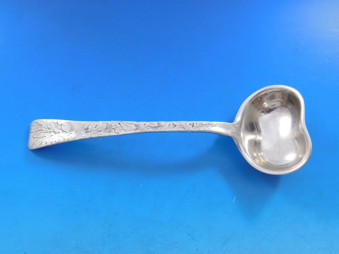 Tiffany & Co Sterling Silver Gravy Ladle Lap Over Edge 7.25": Tiffany & Co Sterling Silver Gravy Ladle Lap Over Edge 7.25" This exquisite sterling silver gravy ladle by Tiffany & Co. features a graceful lap over edge design with a beautiful acid etched leaf and 