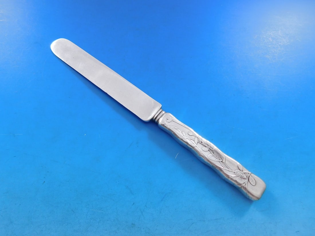 Tiffany Sterling Silver Lap Over Edge Dessert Knife 7.5 Inch with Foliage: Tiffany Sterling Silver Lap Over Edge Dessert Knife 7.5 Inch with Foliage This elegant dessert knife features the exquisite Lap Over Edge pattern, acid etched by Tiffany & Co. Crafted from all-sterlin