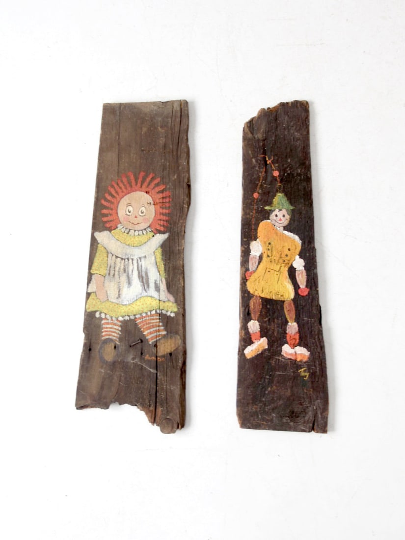 Artist-Signed Vintage Rustic Wood Plaques of Raggedy Ann and Pinocchio: Artist-Signed Vintage Rustic Wood Plaques of Raggedy Ann and Pinocchio This charming pair of vintage rustic wall plaques features hand-painted portraits of Raggedy Ann and Pinocchio on raw wood. Each 