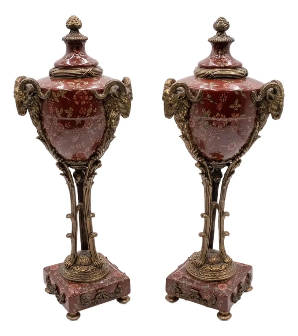 Regency Style Pair of Bronze Porcelain Lidded Urns with Rams Heads: Regency Style Pair of Bronze Porcelain Lidded Urns with Rams Heads This exquisite pair of Castilian bronze and porcelain lidded urns features a stunning Regency style design. Crafted approximately 30 