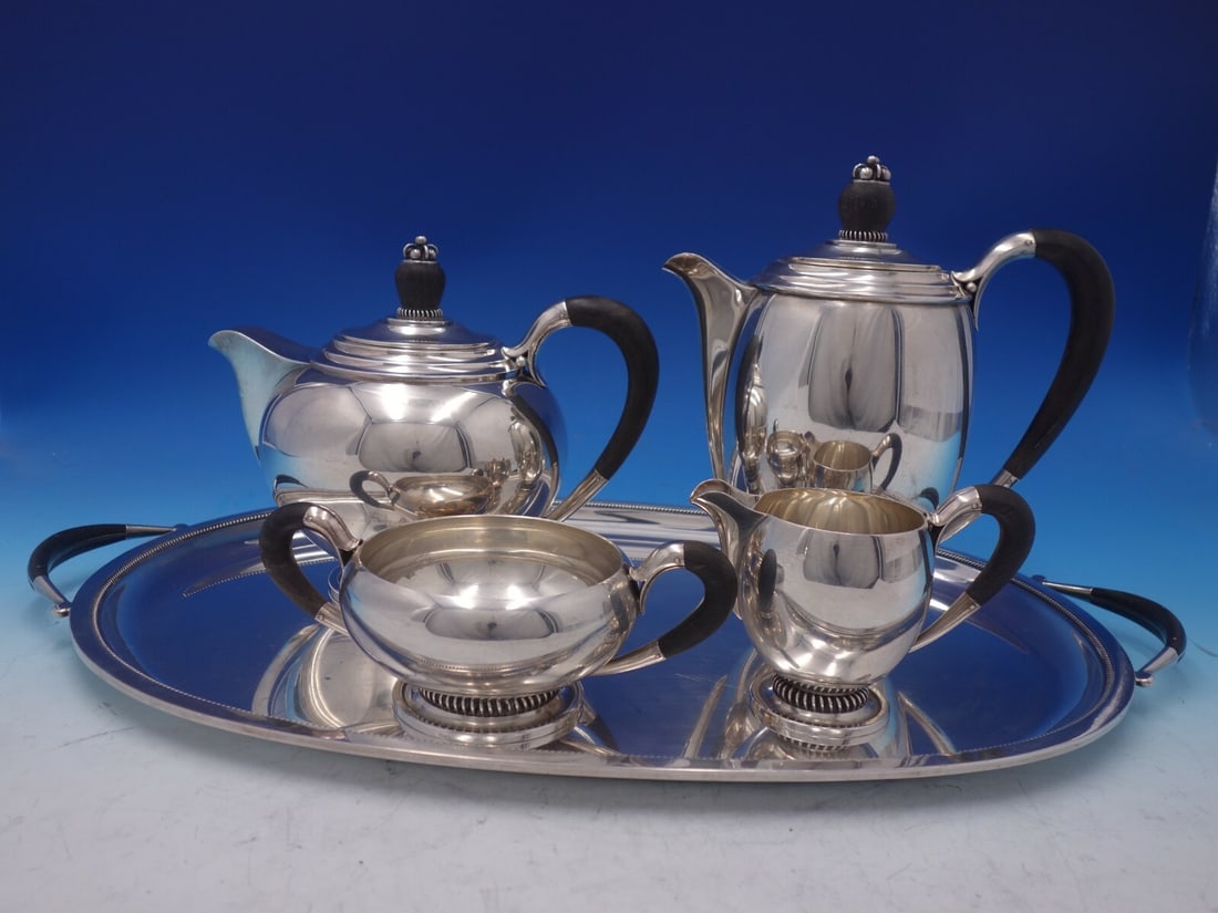 Hermann Sterling Silver 5pc Tea Set with Ebony Handles X52: Hermann Sterling Silver 5pc Tea Set with Ebony Handles X52 This exquisite five-piece tea set by Hermann features elegant sterling silver construction complemented by ebony handles and finials. The set