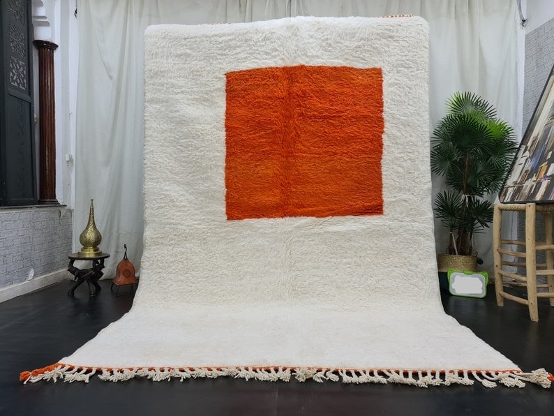 Handmade Moroccan Berber Rug White Wool with Orange Design 9.84 x 6.56 feet: Handmade Moroccan Berber Rug White Wool with Orange Design 9.84 x 6.56 feet Elevate your living space with this stunning Handmade Moroccan Berber Area Rug. Crafted from 100% local sheep wool, this bea