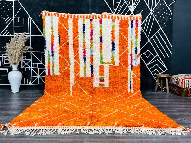 Authentic Handwoven Orange Wool Rug from Morocco 9.84 x 6.56 Feet: Authentic Handwoven Orange Wool Rug from Morocco 9.84 x 6.56 Feet Enhance your living space with this stunning authentic orange wool rug, handwoven in the Atlas Mountains by skilled Berber women weave