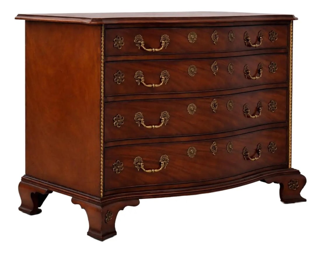 Mahogany Chest With Serpentine Front and Brass Ormolu in Chippendale Design: Mahogany Chest With Serpentine Front and Brass Ormolu in Chippendale Design This Baker Georgian chest features a serpentine curved front and is crafted from mahogany with a distressed finish. Inspired