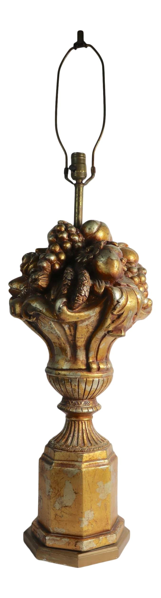 Continental Art Co 1966 Gilt Floral Urn Table Lamp Gold Plaster: Continental Art Co 1966 Gilt Floral Urn Table Lamp Gold Plaster This elegant table lamp showcases a stylish faux gilt finish and is designed in the form of a classical urn adorned with a bounty of fru