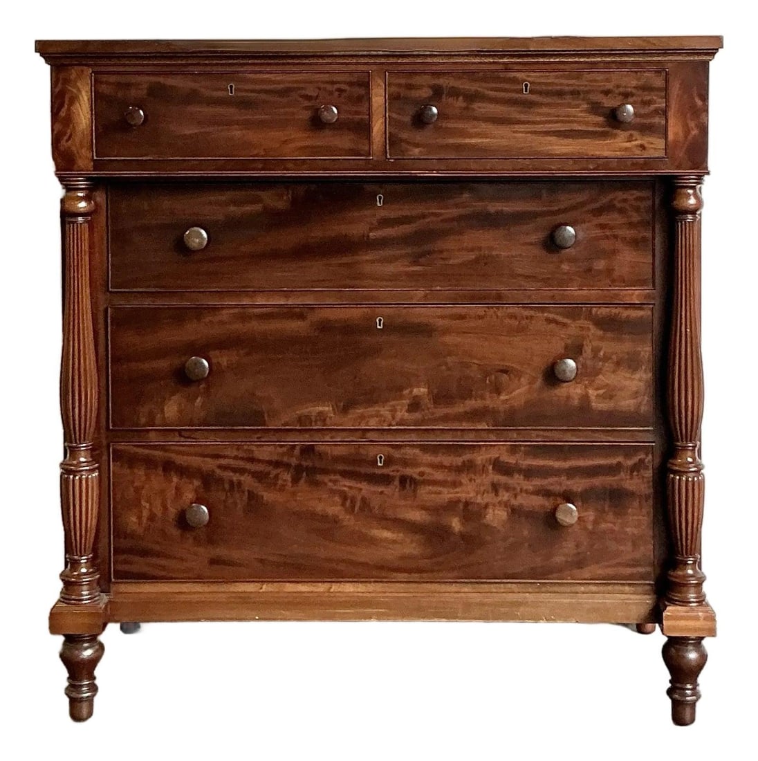 Federal Style Flame Mahogany Tall Chest with Turned Legs and Classic Pulls: Federal Style Flame Mahogany Tall Chest with Turned Legs and Classic Pulls This vintage Federal-style tall chest of drawers is crafted from striking flame mahogany, showcasing the wood's exceptional g