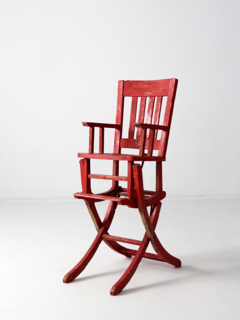 1920 Antique Red Convertible Rocking Chair High Chair: 1920 Antique Red Convertible Rocking Chair High Chair This charming antique wooden convertible high chair transforms into a rocking chair, dating back to circa 1920. Adorned in a bold red paint, this 