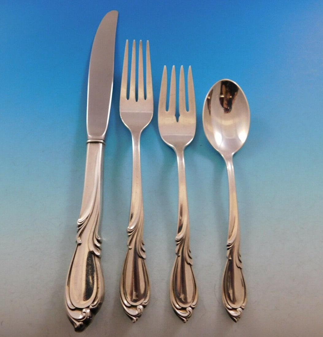 Rhapsody New by International Sterling Silver 4-Piece Place Setting: Rhapsody New by International Sterling Silver 4-Piece Place Setting Experience the elegance of the Rhapsody New pattern by International Sterling Silver. This exquisite 4-piece regular size place sett