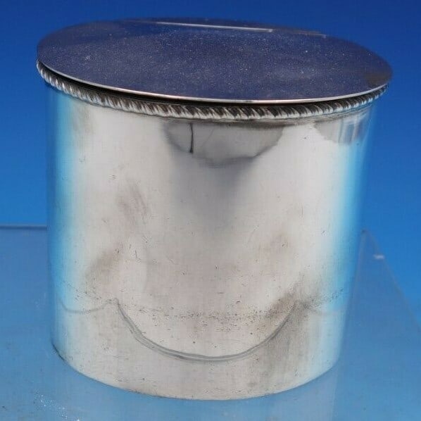 Handcrafted Sterling Silver Oval Tea Caddy with Hinged Lid: Handcrafted Sterling Silver Oval Tea Caddy with Hinged Lid This exquisite handmade tea caddy is crafted from sterling silver, featuring an elegant oval shape with a hinged lid and a decorative rope bo
