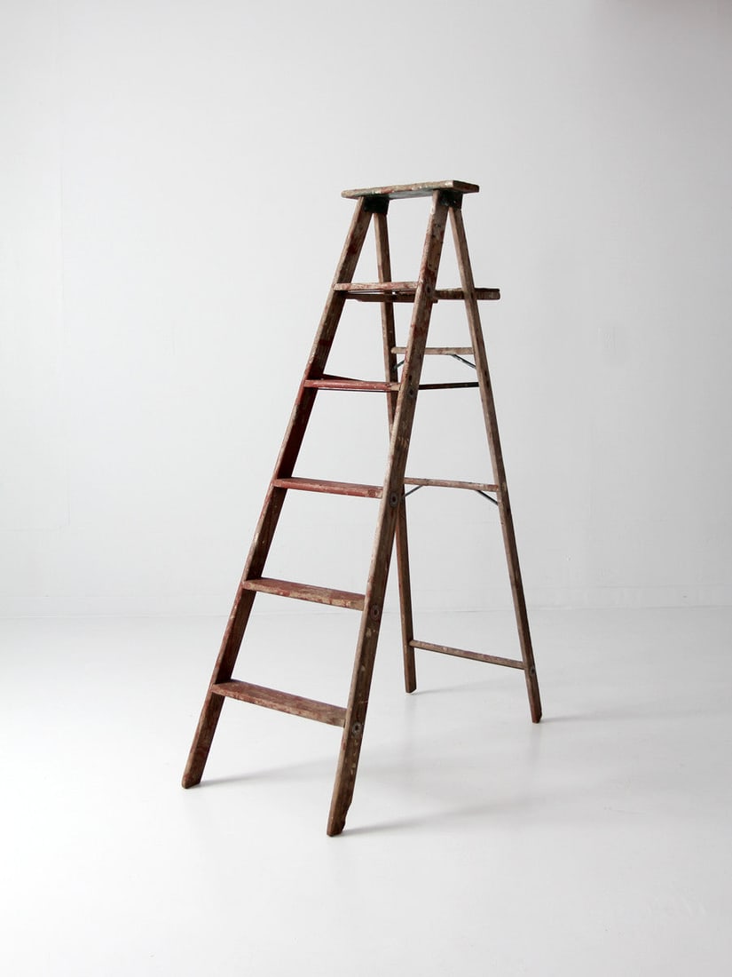Five Rung Vintage Red Wood Painter Ladder 5.5 Feet: Five Rung Vintage Red Wood Painter Ladder 5.5 Feet This vintage red wooden painter's ladder features five rungs and showcases layers of aged paint, primarily red, giving it distinctive character. Silv