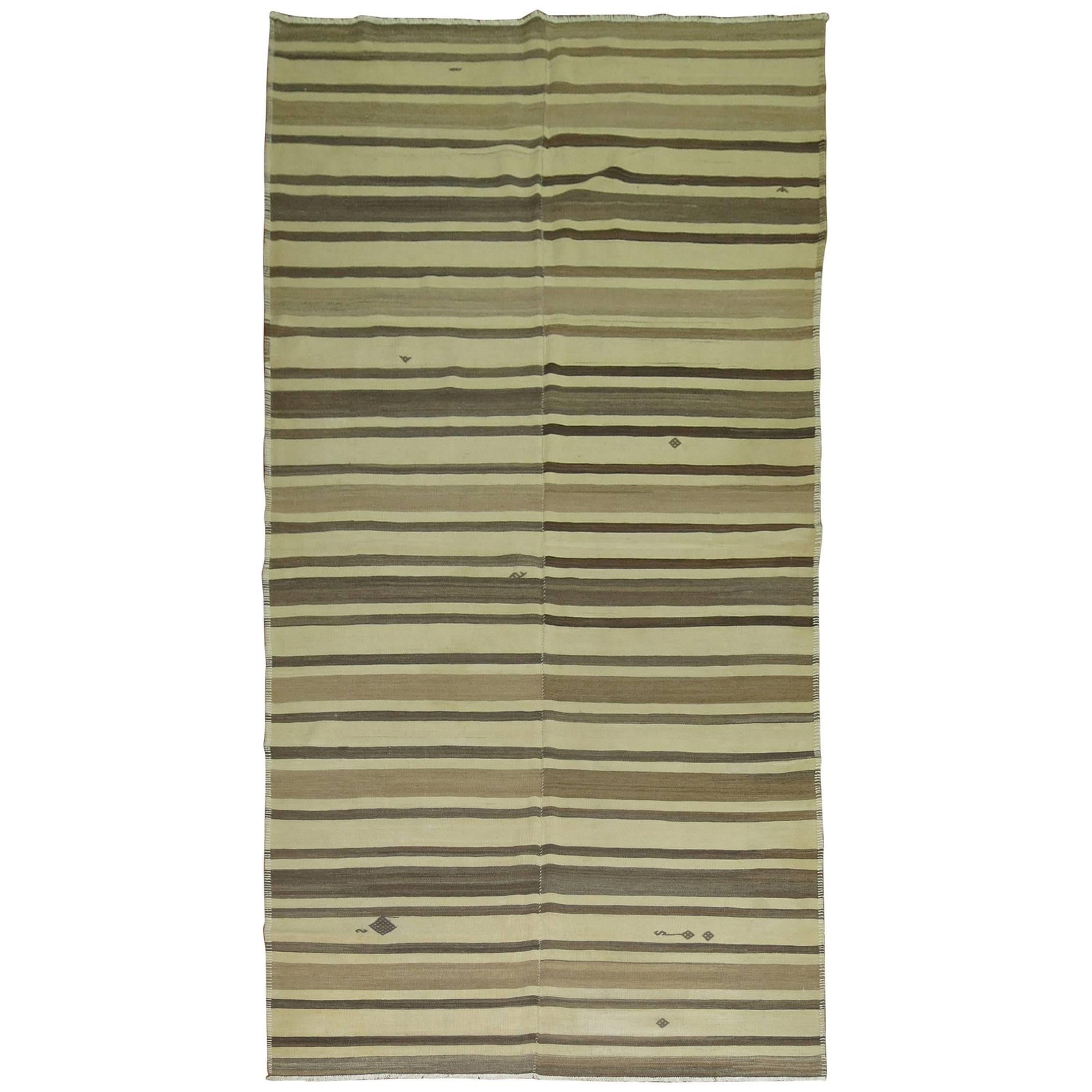 Mid Century Wool Hand Knotted Turkish Striped Kilim Rug: Mid Century Wool Hand Knotted Turkish Striped Kilim Rug This vintage Turkish kilim features a striking striped motif in shades of brown and cream, adding a touch of Mid-Century Modern style to any spa