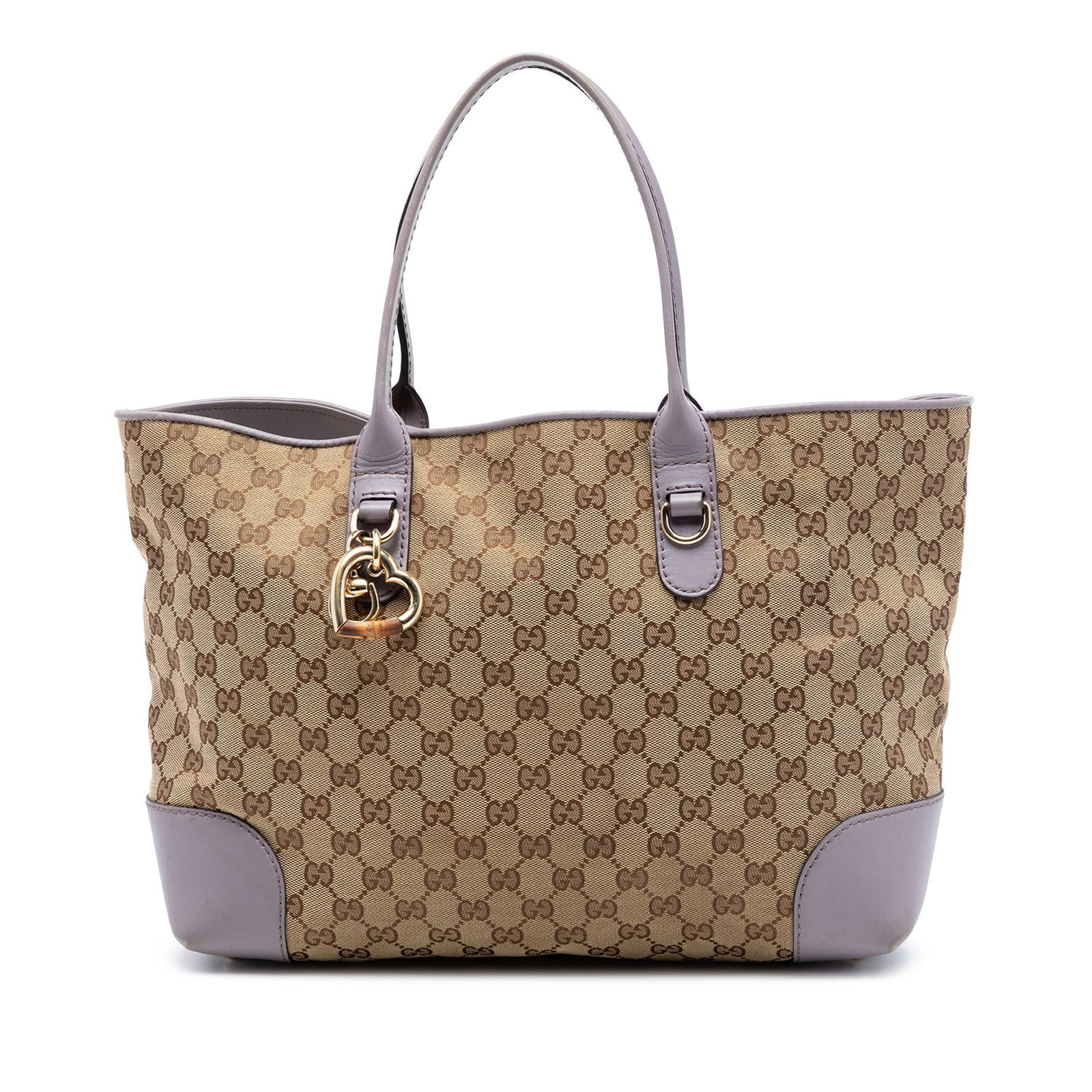 Gucci GG Canvas Heart Bit Tote Bag: Gucci GG Canvas Heart Bit Tote Bag This Gucci GG Canvas Heart Bit Tote features a beige canvas body with leather trim and is accented by a metal charm with bamboo detail. The bag offers flat leather s