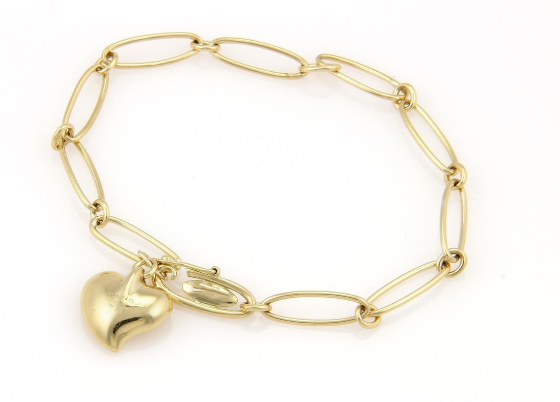 Tiffany & Co. Elsa Peretti 18k Gold Heart Bracelet Oval Chain: Tiffany & Co. Elsa Peretti 18k Gold Heart Bracelet Oval Chain This elegant bracelet from Tiffany & Co.'s Curved Heart collection, designed by Elsa Peretti, is crafted from premium 18k yellow gold feat