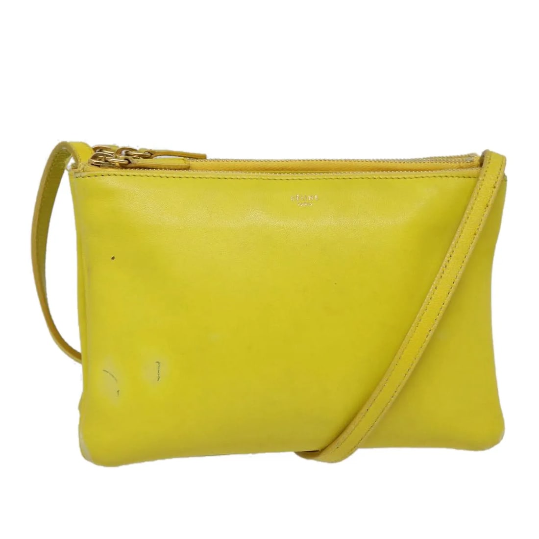 Celine Trio Yellow Leather Shoulder Bag: Celine Trio Yellow Leather Shoulder Bag Celine Trio leather bag in yellow. Made in Italy, this piece is presented in fair overall condition with visible wear throughout. The exterior shows loss of sha