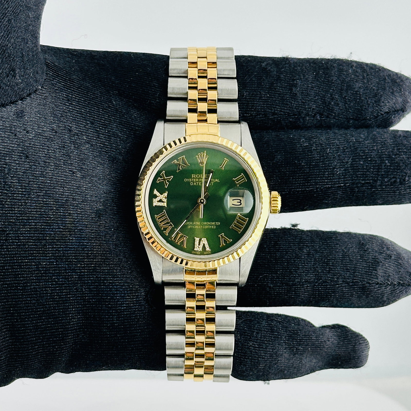 Rolex Datejust aftermarket green Roman diamond dial Jubilee 16013: Rolex Datejust aftermarket green Roman diamond dial Jubilee 16013 This men's Rolex Datejust features an aftermarket green dial with Roman numerals at the 6 and 9 positions, each set with diamonds. The