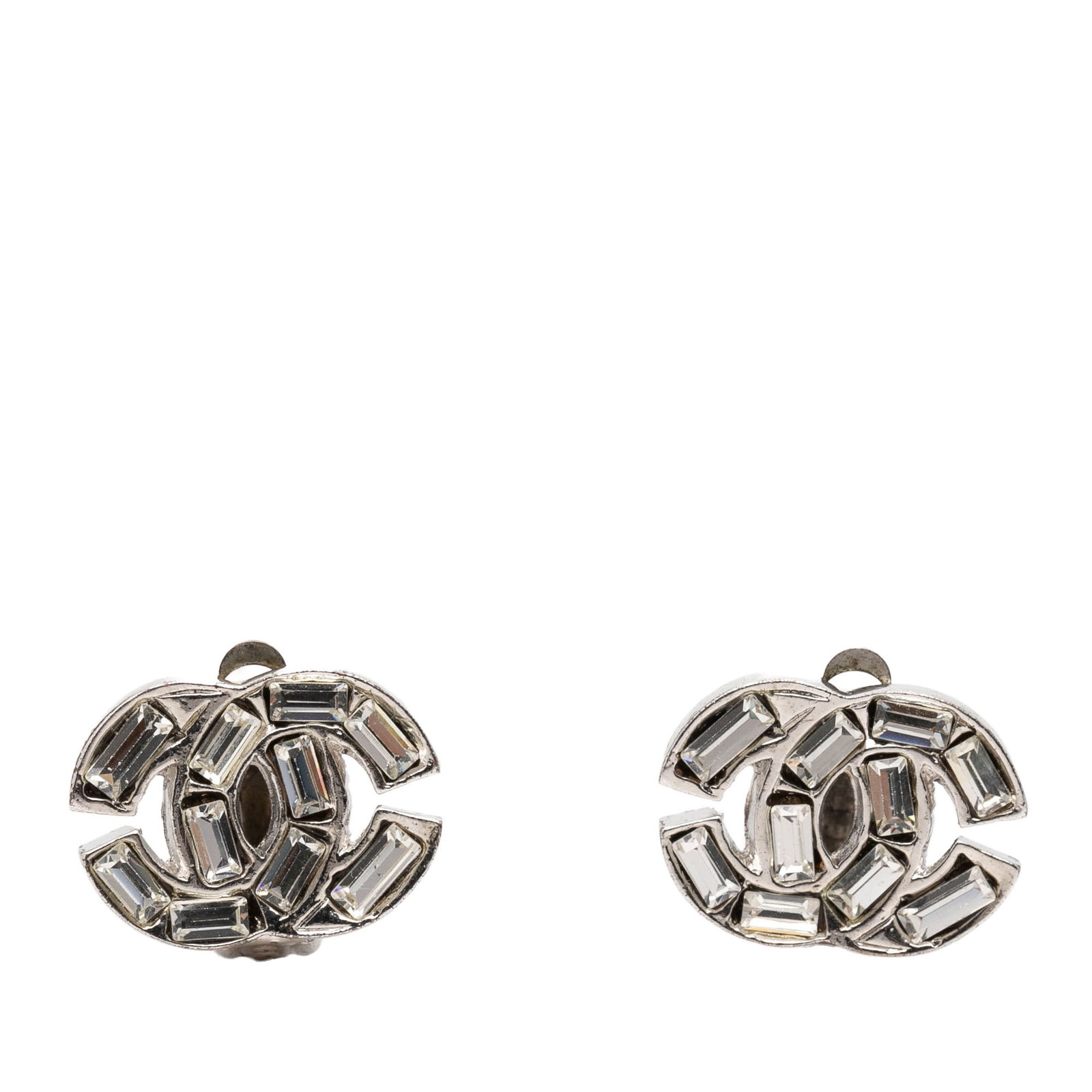 Chanel Silver Plated Strass Clip On Earrings CC: Chanel Silver Plated Strass Clip On Earrings CC These Chanel CC clip-on earrings feature a silver-plated metal construction adorned with strass embellishments. Made in France, these costume jewelry ea