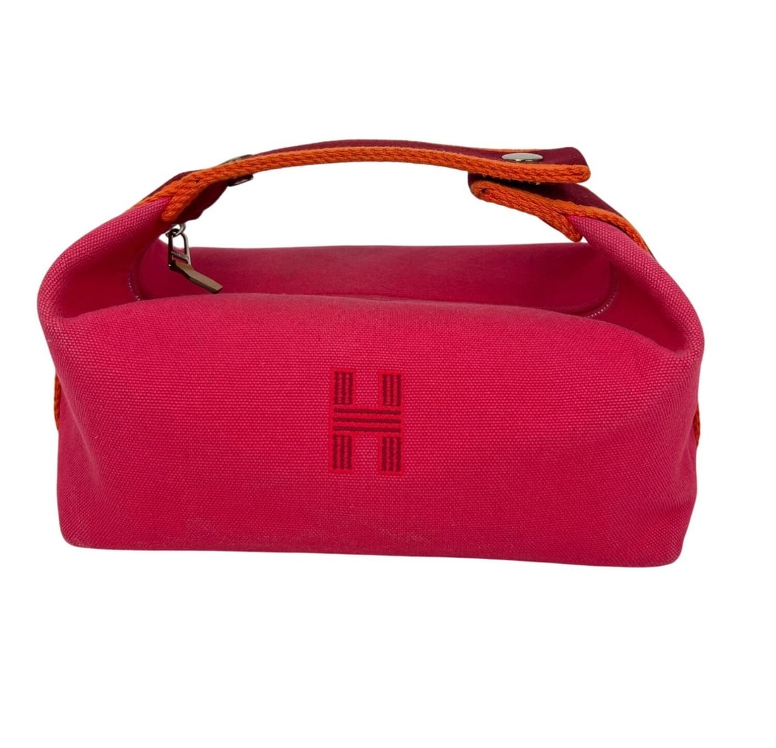 HERMES Bride-A-Brac Pink Canvas Pouch Bag: HERMES Bride-A-Brac Pink Canvas Pouch Bag This Hermes Small Canvas Bride A-Brac pouch bag features a solid pink exterior in a rectangular shape with a matte finish. It has a zip closure and multicolor