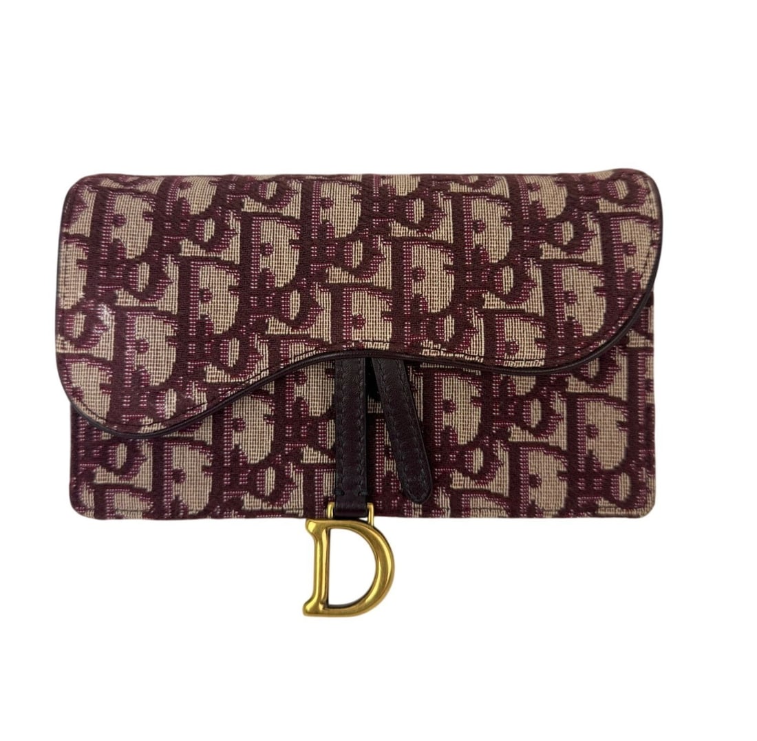 Dior Saddle Oblique Canvas Bordeaux Belt Bag and Clutch: Dior Saddle Oblique Canvas Bordeaux Belt Bag and Clutch This Christian Dior Oblique Saddle belt bag clutch features a rectangular silhouette crafted from red canvas with a matte finish and Dior's icon
