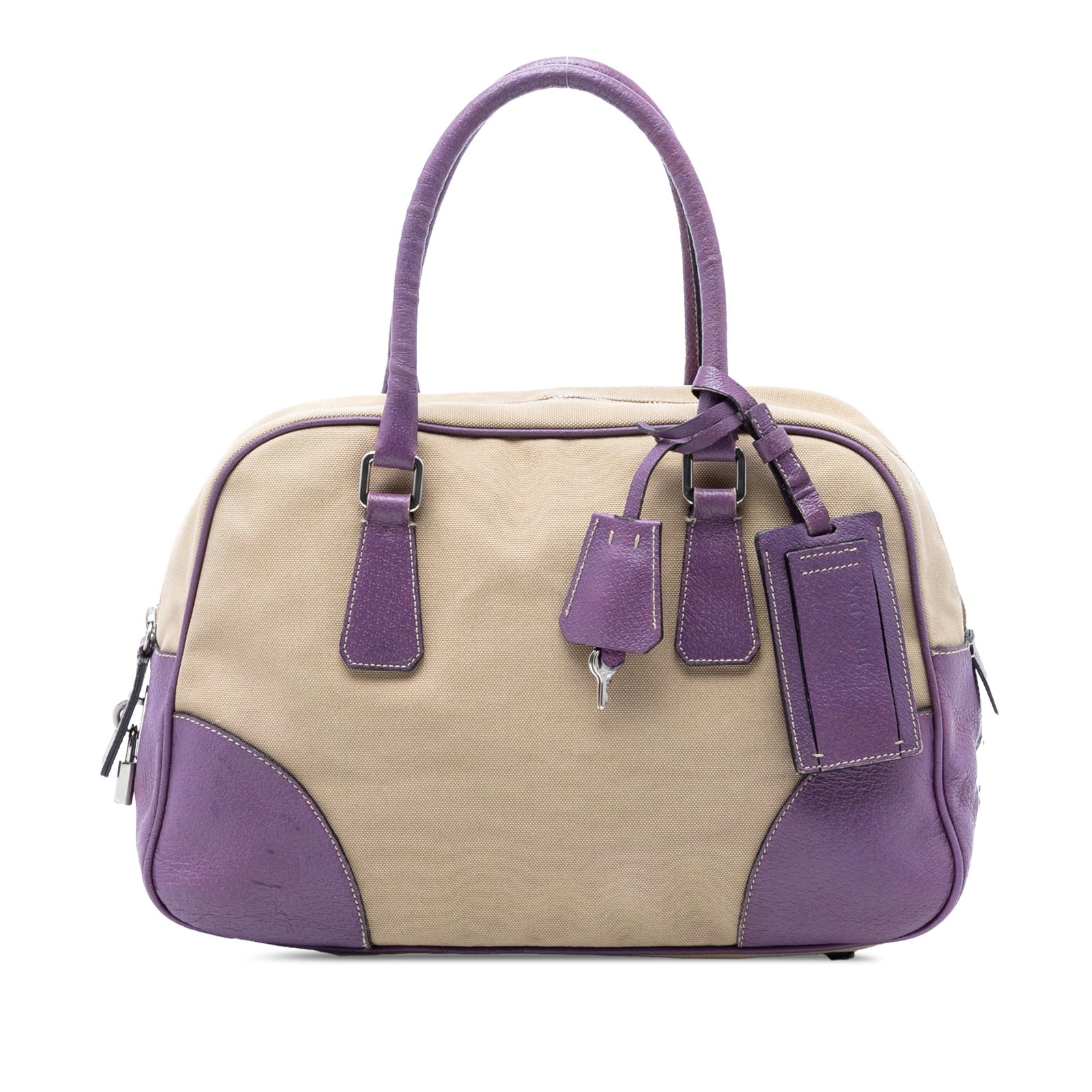 Prada Canapa Bauletto canvas tote with leather trim: Prada Canapa Bauletto canvas tote with leather trim This Prada Cinghiale Trimmed Canvas Canapa Bauletto Bag features a beige canvas body with leather trim, rolled leather handles, a top zip closure, a