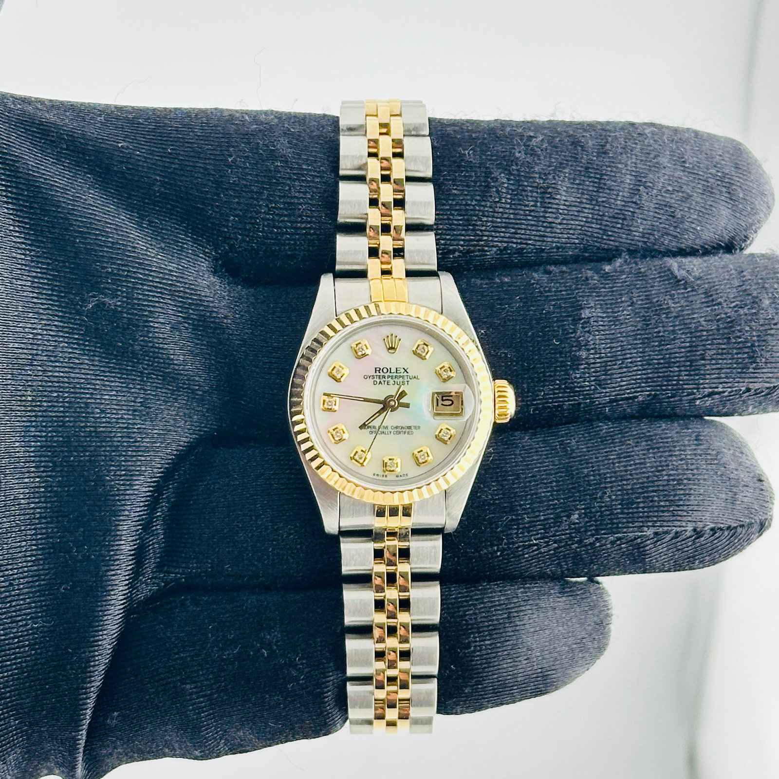 Rolex Datejust Lady Aftermarket White MOP Diamond Dial Jubilee Ref 69173: Rolex Datejust Lady Aftermarket White MOP Diamond Dial Jubilee Ref 69173 This ladies' Rolex Datejust features an aftermarket white mother-of-pearl dial with yellow diamond markers, set in a fluted bez