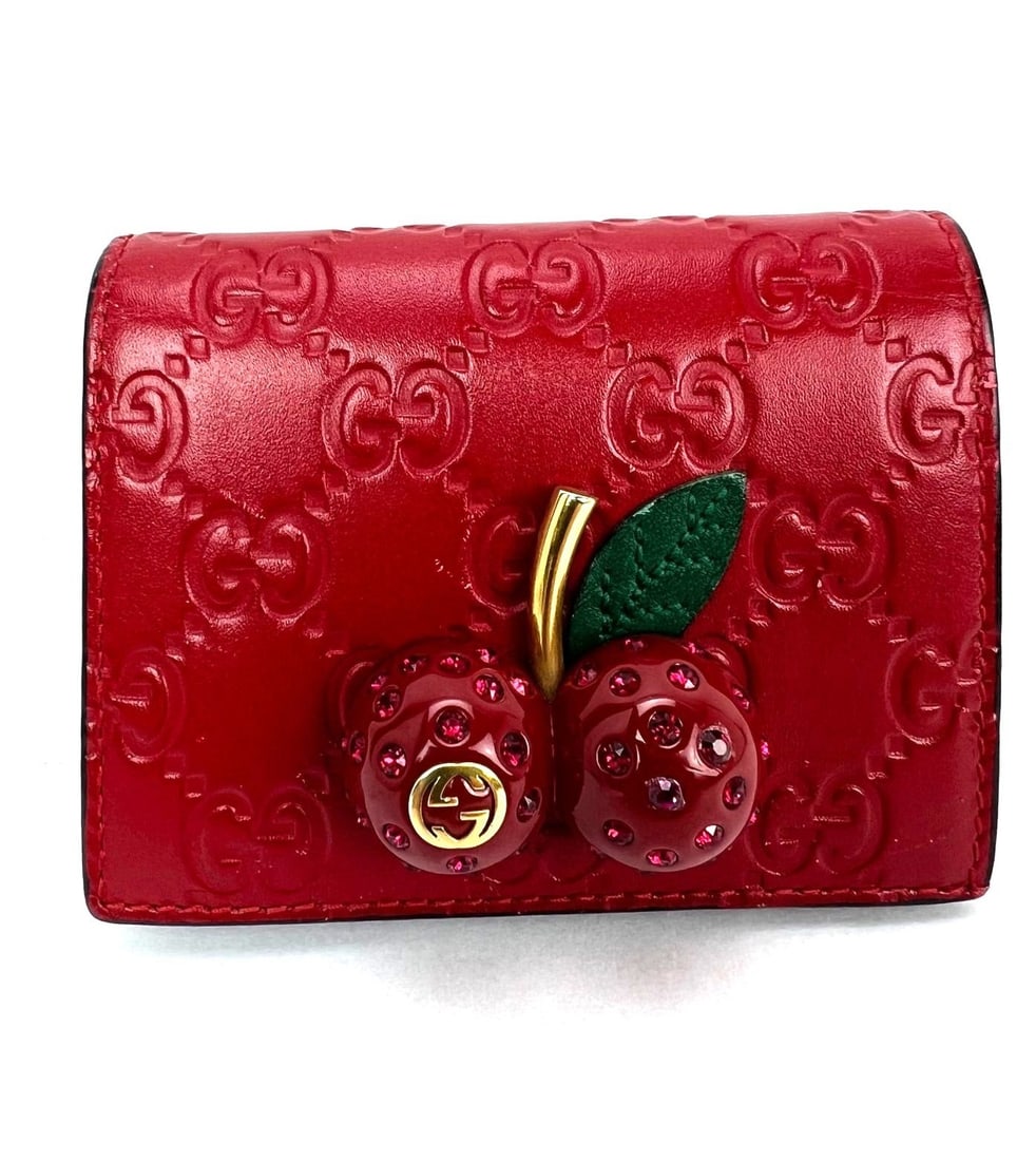 Gucci Guccissima Red Leather Bifold Wallet with Cherries: Gucci Guccissima Red Leather Bifold Wallet with Cherries Compact red leather bifold wallet from Gucci with a solid pattern and credit card storage. This pre-owned women's wallet is made in Italy. Spec
