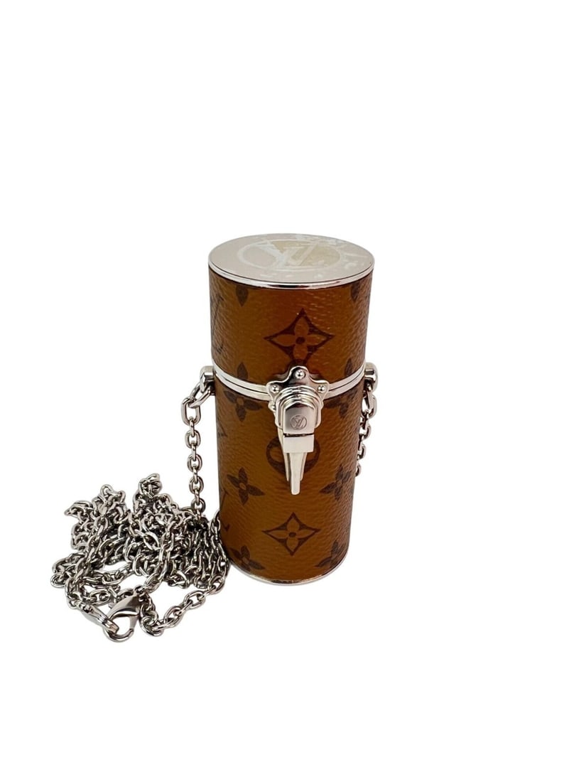 Louis Vuitton Small Brown Canvas Monogram Lipstick Case with Chain and Box: Louis Vuitton Small Brown Canvas Monogram Lipstick Case with Chain and Box This Louis Vuitton Reverse Monogram Chain Lipstick Case features the iconic monogram canvas in brown with a silver-tone chain