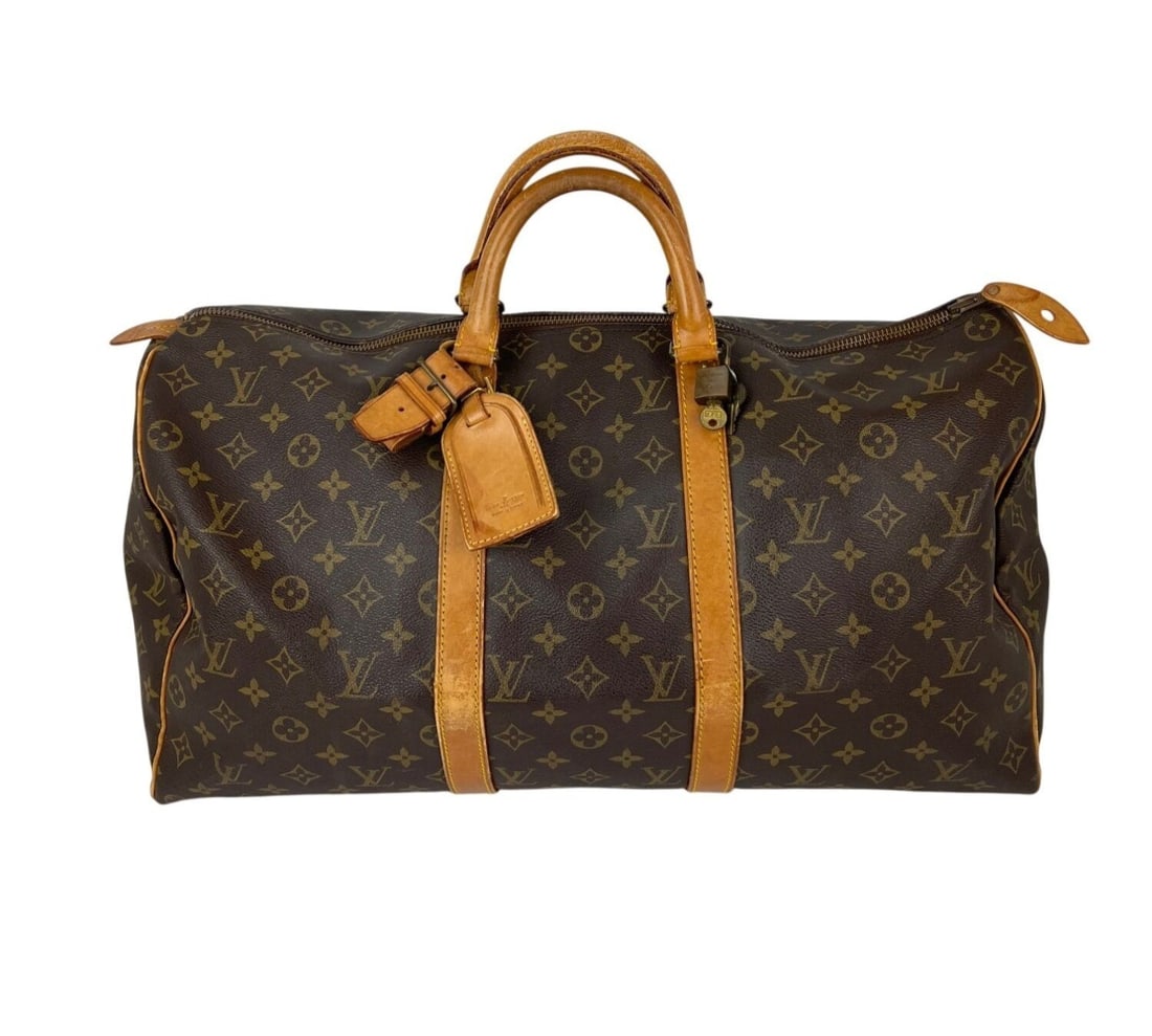 Louis Vuitton Keepall 50 Monogram Canvas Vintage Travel Duffle with Luggage Tag: Louis Vuitton Keepall 50 Monogram Canvas Vintage Travel Duffle with Luggage Tag This Louis Vuitton Keepall 50 is a vintage duffle bag crafted from signature monogram coated canvas with brown leather d