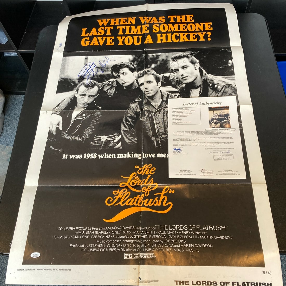 Sylvester Stallone Henry Winkler Signed Lords Of Flatbush 27x41 Movie Poster JSA: Sylvester Stallone Henry Winkler Signed Lords Of Flatbush 27x41 Movie Poster JSA This is an original movie poster for 'The Lords of Flatbush,' featuring the signatures of renowned actors Sylvester Sta