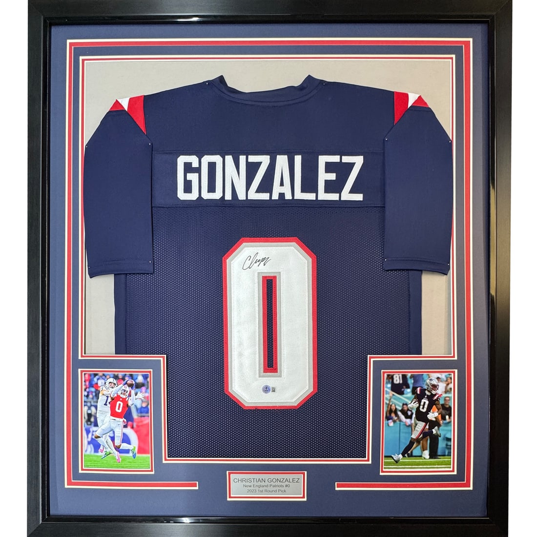 Christian Gonzalez Signed Patriots Blue Jersey 35x39 Framed Beckett Authenticated: Christian Gonzalez Signed Patriots Blue Jersey 35x39 Framed Beckett Authenticated This professionally framed and matted display features a blue New England Patriots jersey autographed by Christian Gon