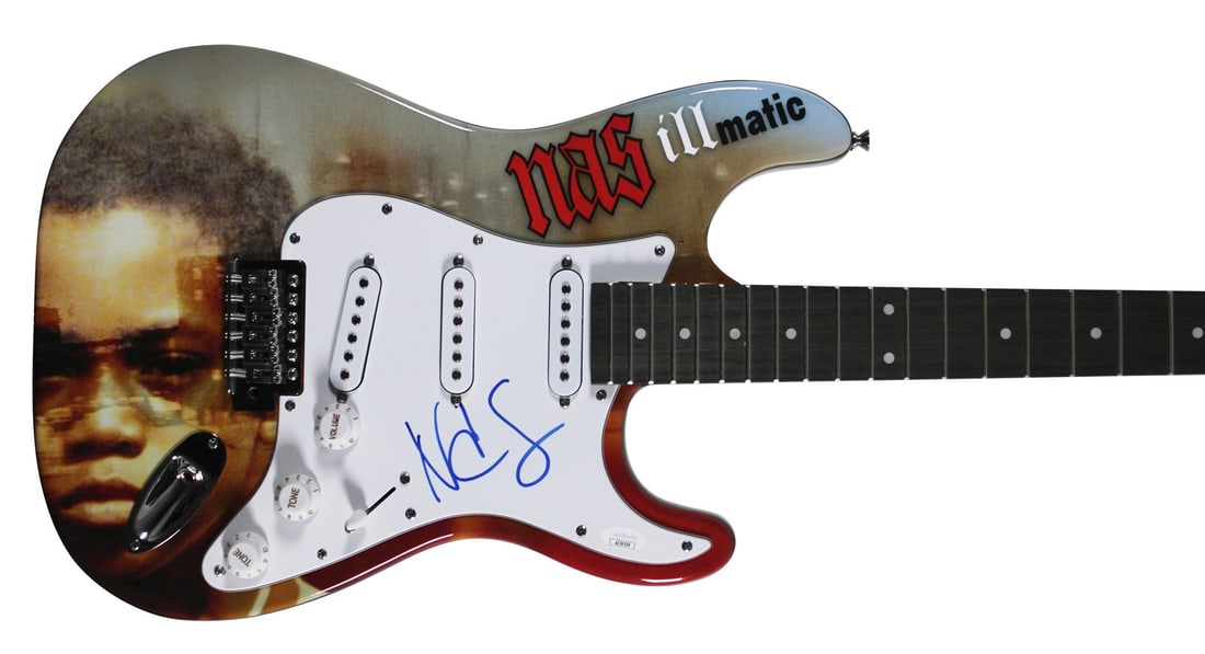 JSA authenticated Nas signed Glarry electric guitar with pick: JSA authenticated Nas signed Glarry electric guitar with pick This pre-owned Glarry electric guitar has been personally autographed by Nas. The guitar is unstrung and comes authenticated by JSA, with 