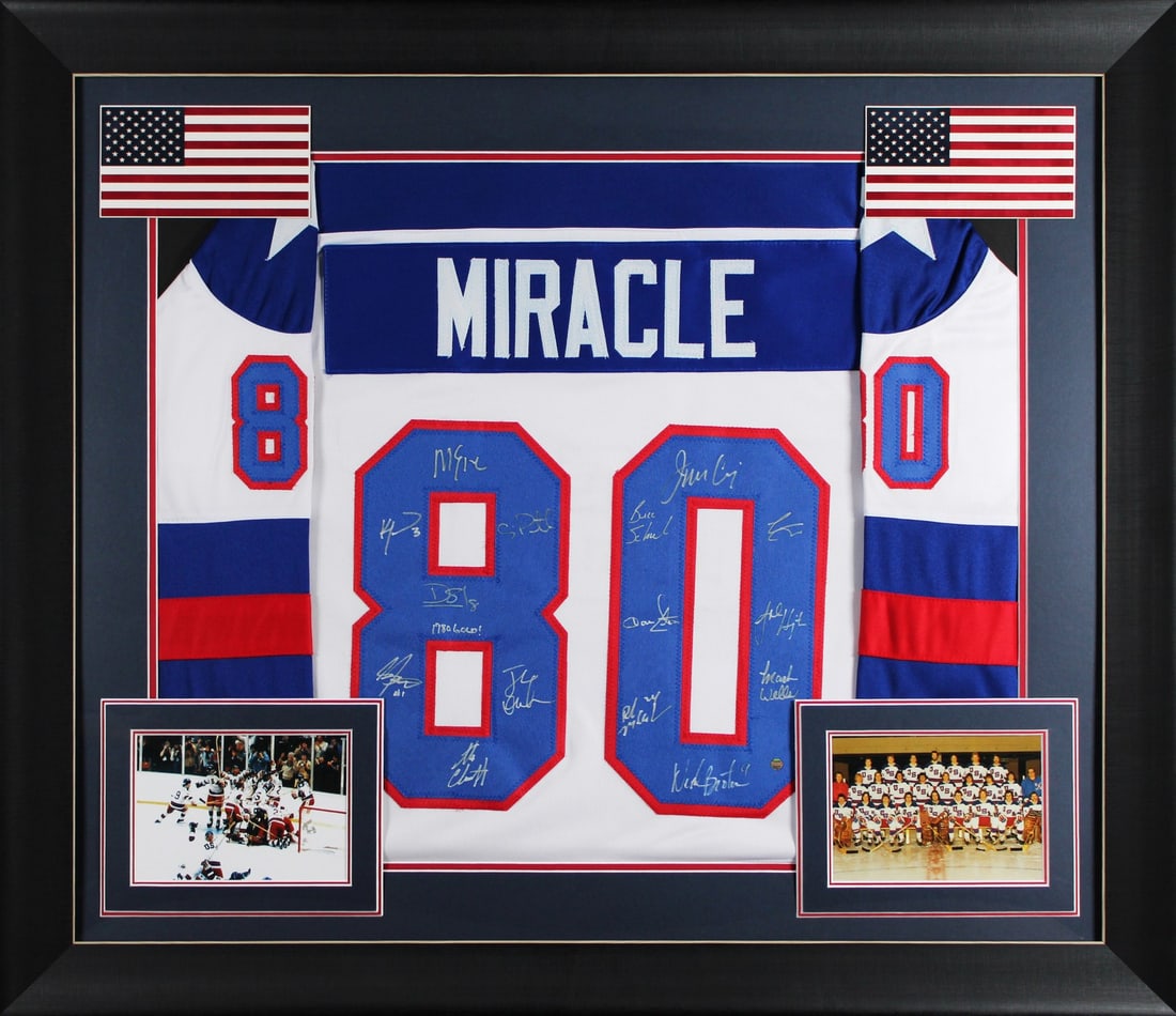 Framed USA 1980 Hockey Jersey Signed by Fifteen Team Members with Steiner COA: Framed USA 1980 Hockey Jersey Signed by Fifteen Team Members with Steiner COA This white pro-style jersey commemorates the 1980 USA Hockey team and has been personally signed by fifteen team members, 