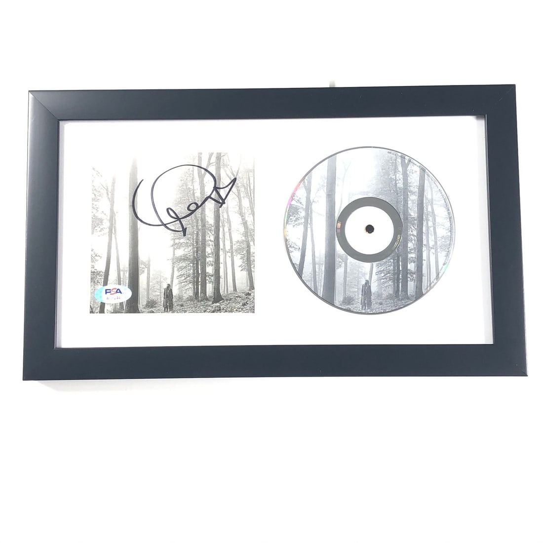 Framed Folklore CD Booklet Taylor Swift PSA DNA Autograph: Framed Folklore CD Booklet Taylor Swift PSA DNA Autograph This framed CD album cover features an authentic autograph by Taylor Swift on the "Folklore" cover. The signature has been professionally auth