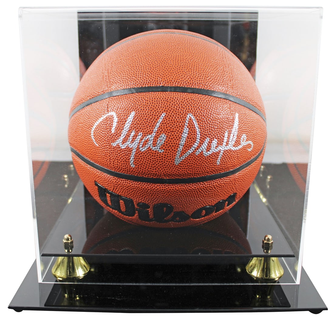 Clyde Drexler Signed Wilson Basketball Displayed in Case Beckett Witnessed: Clyde Drexler Signed Wilson Basketball Displayed in Case Beckett Witnessed This Wilson indoor/outdoor basketball has been personally signed by Clyde Drexler of the Houston Rockets. The item includes a