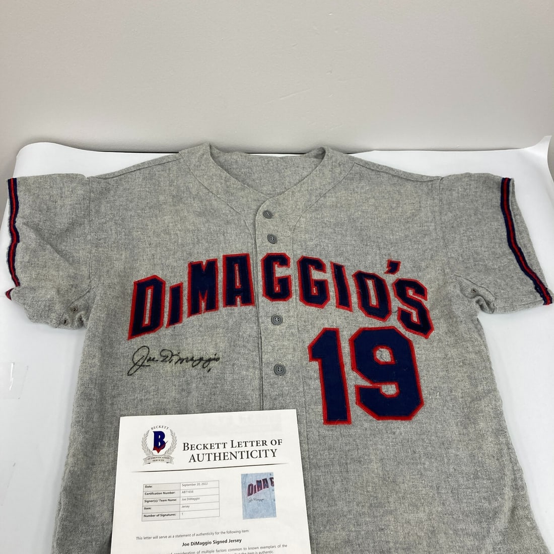 Joe DiMaggio Signed 1960s Jersey New York Yankees Beckett COA: Joe DiMaggio Signed 1960s Jersey New York Yankees Beckett COA This original 1960's baseball jersey is signed by the legendary Joe DiMaggio, a Hall of Famer known for his remarkable career with the New