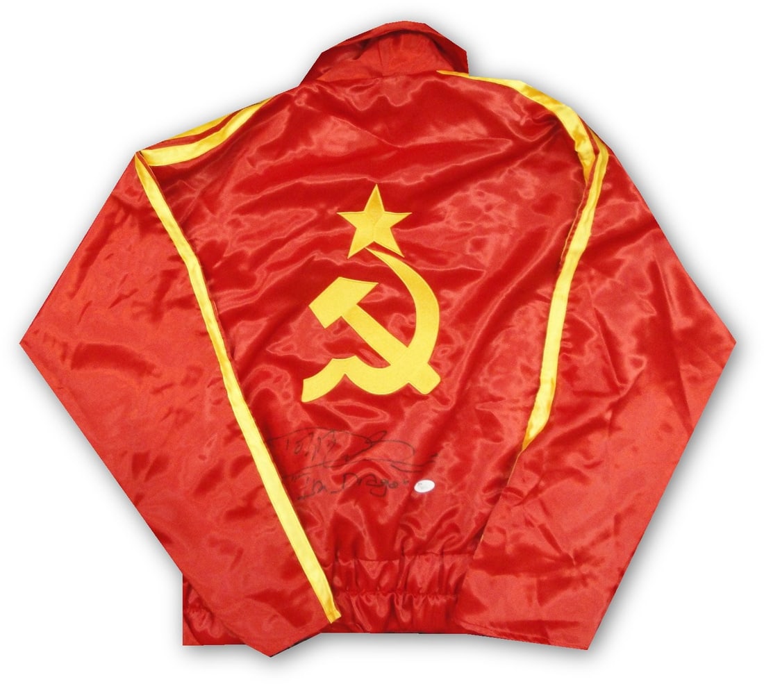 Dolph Lundgren signed JSA boxing robe Drago Rocky IV: Dolph Lundgren signed JSA boxing robe Drago Rocky IV This is a pre-owned boxing robe autographed by Dolph Lundgren, known for his role as Ivan Drago in Rocky IV. The signature is authenticated by
