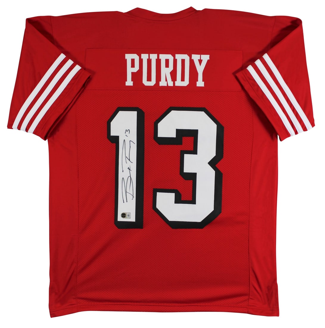 Brock Purdy BAS Witnessed Red Pro Style Jersey San Francisco 49ers: Brock Purdy BAS Witnessed Red Pro Style Jersey San Francisco 49ers This red pro style jersey features a dropshadow design and has been personally hand-signed by Brock Purdy of the San Francisco 49ers.