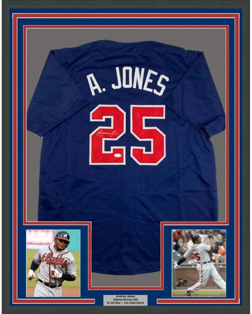 Framed Andruw Jones Autographed Blue Jersey with JSA COA: Framed Andruw Jones Autographed Blue Jersey with JSA COA This framed and autographed Andruw Jones jersey is a must-have for any Atlanta Braves fan. The jersey, measuring 33"x42", is showcased in a pro