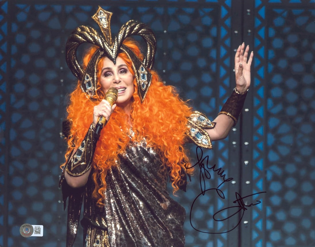 Cher signed 11x14 photo inscribed Love Beckett BAS BL81365: Cher signed 11x14 photo inscribed Love Beckett BAS BL81365 Autographed horizontal 11x14 photograph personally signed by Cher with the inscription "Love." The item is an original piece from the Here We