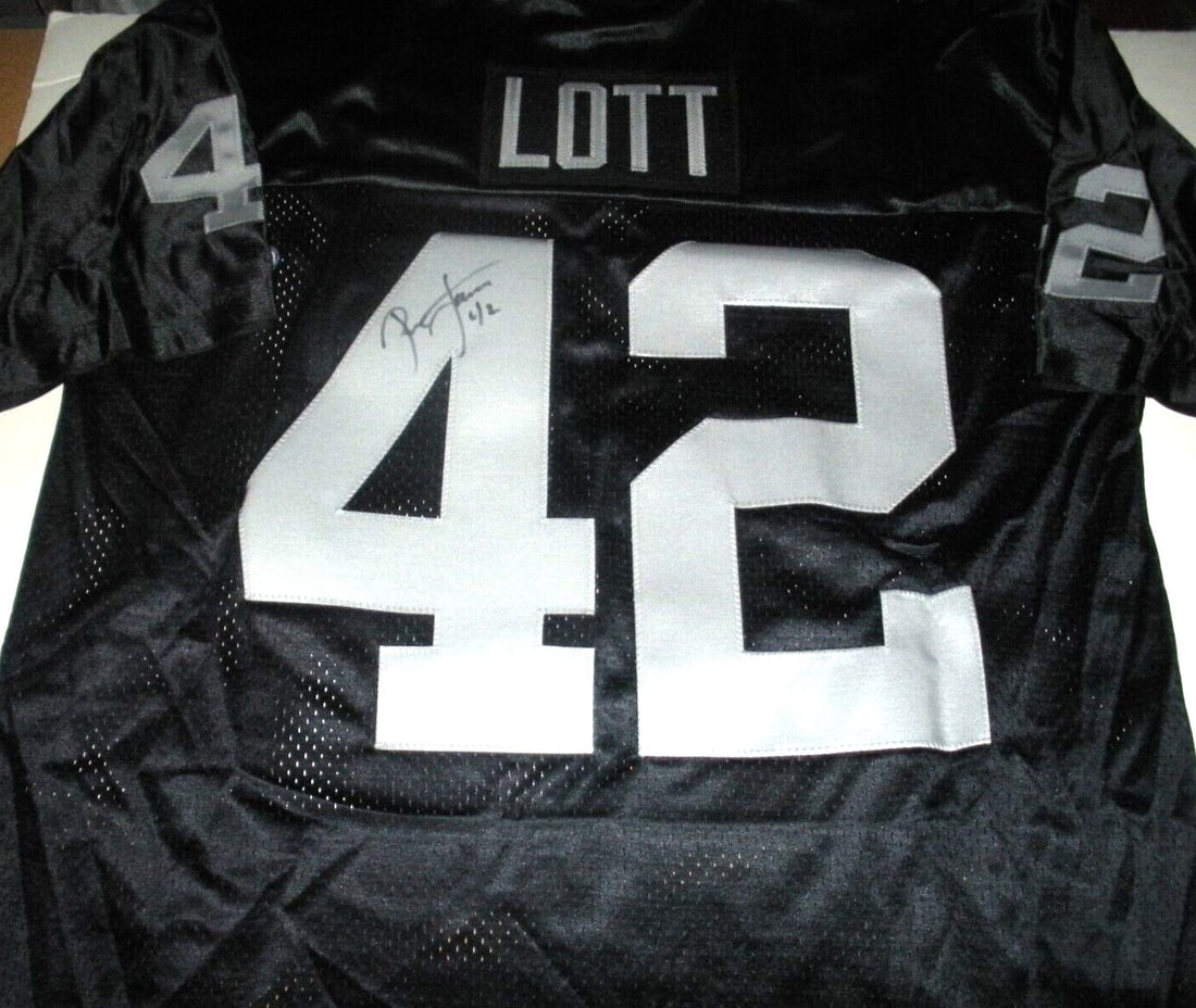 Ronnie Lott Signed Oakland Raiders Champion Jersey with COA: Ronnie Lott Signed Oakland Raiders Champion Jersey with COA Celebrate the legacy of football with this officially licensed Champion jersey signed by Hall of Famer Ronnie Lott, who is renowned for his 