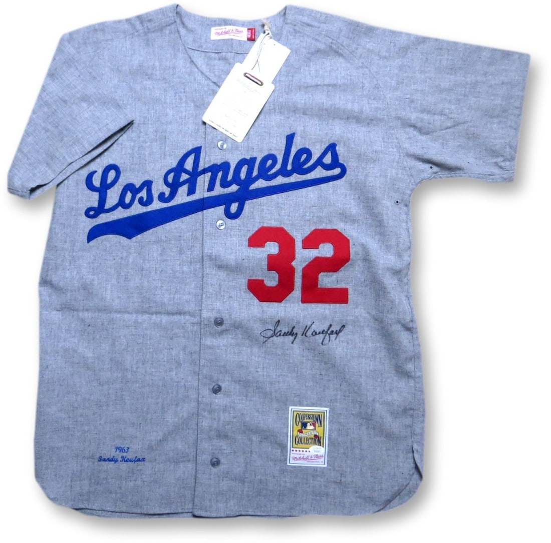 Sandy Koufax Autographed Mitchell & Ness Jersey Dodgers 1963 JSA: Sandy Koufax Autographed Mitchell & Ness Jersey Dodgers 1963 JSA Celebrate the legacy of baseball legend Sandy Koufax with this authentic Mitchell & Ness jersey, featuring his signature. This original