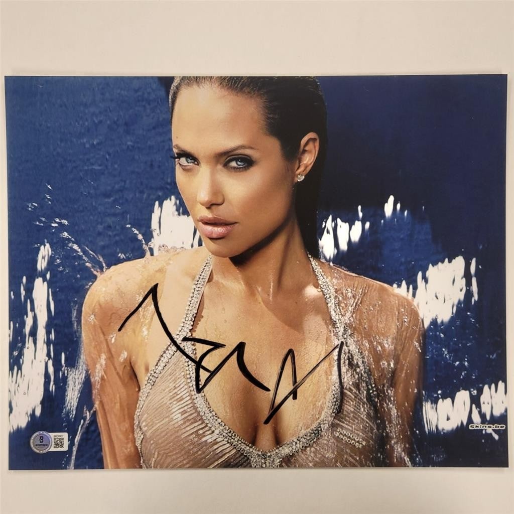 11x14 photograph signed by Angelina Jolie as Lara Croft Beckett authenticated: 11x14 photograph signed by Angelina Jolie as Lara Croft Beckett authenticated This is an original 11x14 photograph signed by Angelina Jolie in her role as Lara Croft. The autograph is authenticated by