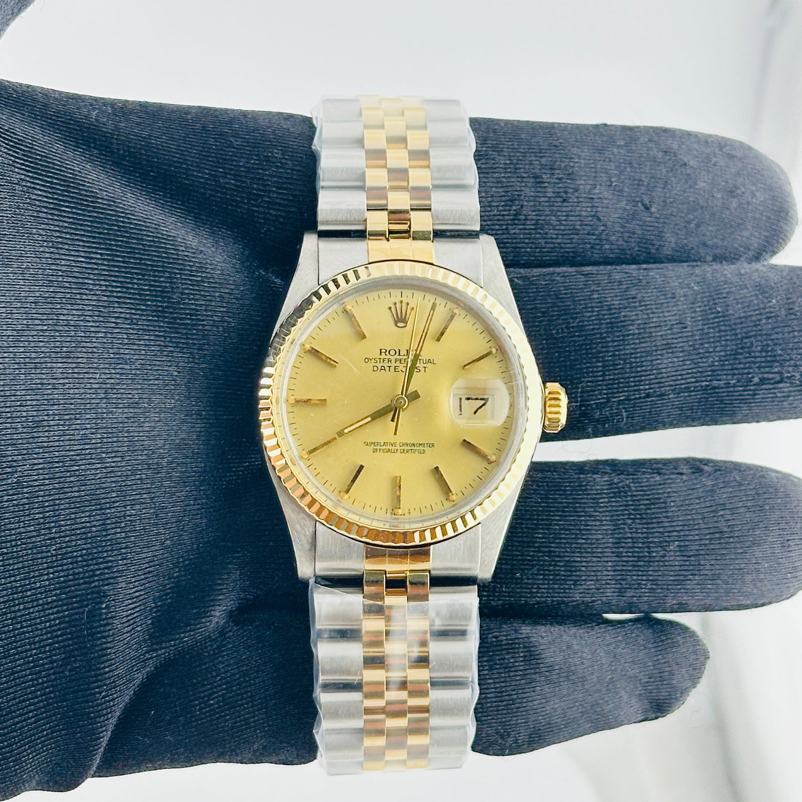 Rolex Datejust 16013 Champagne Stick Dial Aftermarket Jubilee Bracelet: Rolex Datejust 16013 Champagne Stick Dial Aftermarket Jubilee Bracelet This Rolex Datejust features a champagne stick dial and a fluted bezel, paired with an aftermarket Jubilee bracelet. The watch is