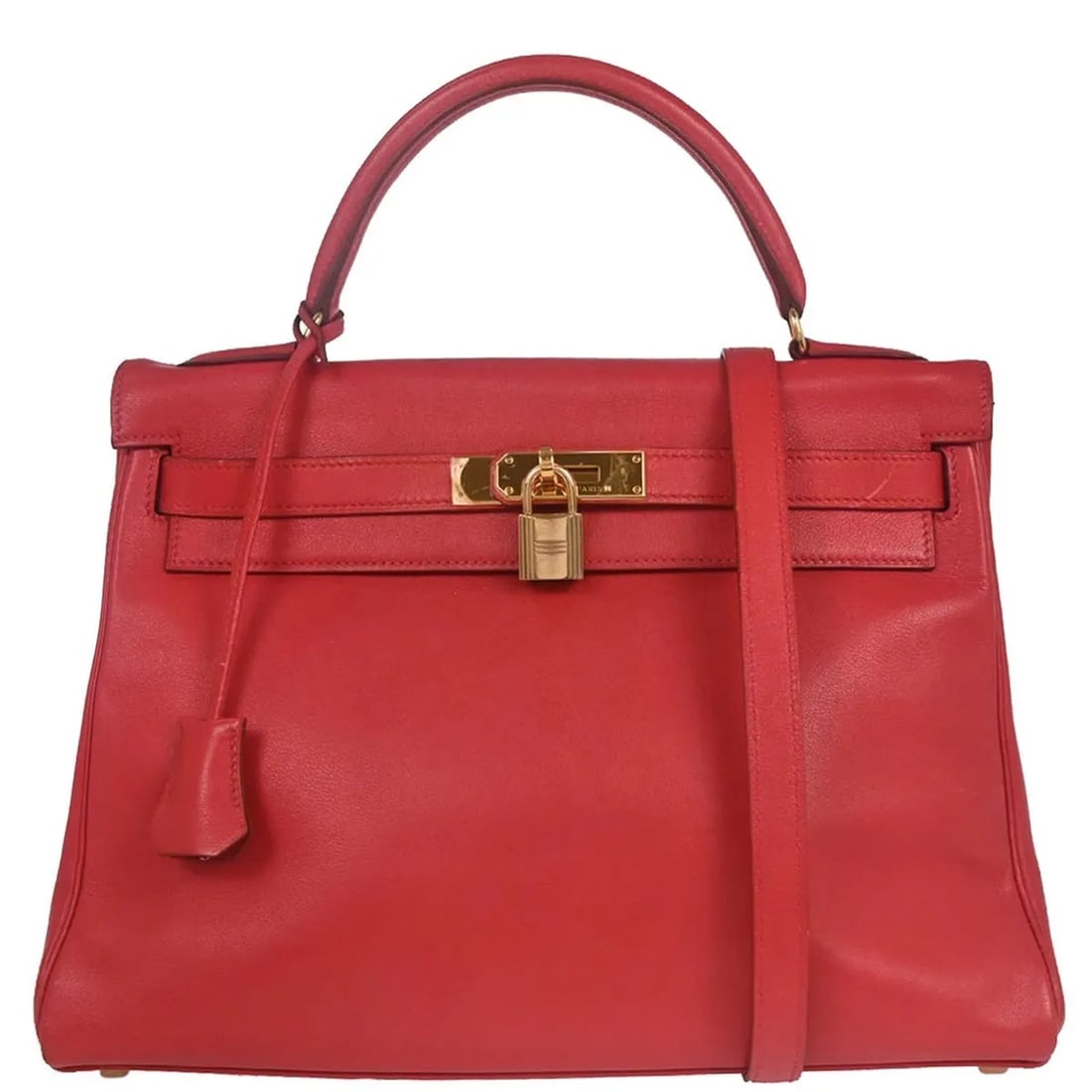 Hermes Kelly leather handbag in red with gold tone hardware: Hermes Kelly leather handbag in red with gold tone hardware Hermes Kelly handbag in red leather with a structured silhouette and gold hardware. Made in France, this piece is in good condition with vis